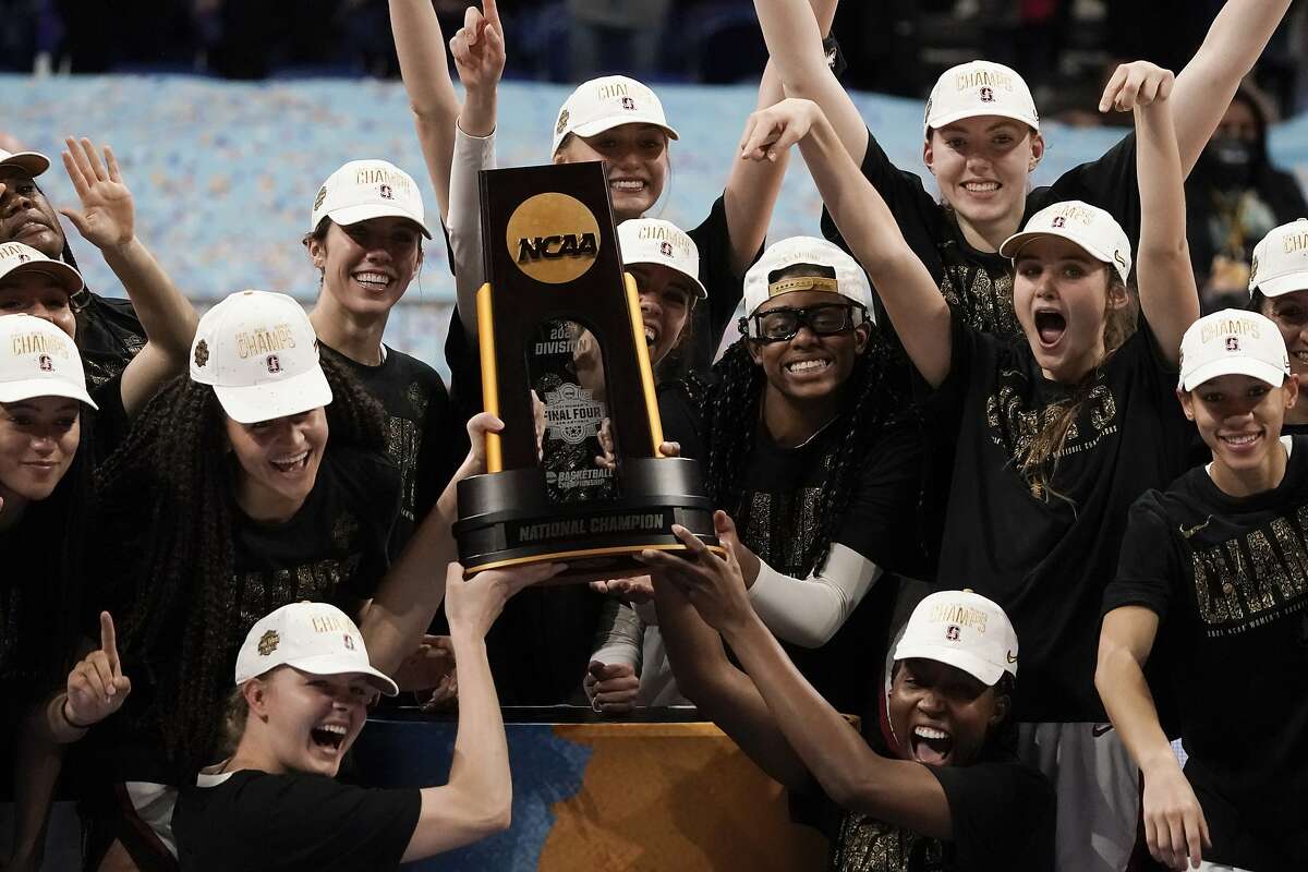 Stanford players celebrate with the trophy after the championship game against Arizona in the women's Final Four NCAA college basketball tournament, Sunday, April 4, 2021, at the Alamodome in San Antonio. Stanford won 54-53. (AP Photo/Morry Gash)
