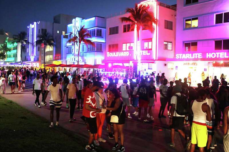 People enjoy themselves as they walk along Ocean Drive on March 18, 2021, in Miami Beach, Florida. College students arrived in the South Florida area for the annual spring break ritual.