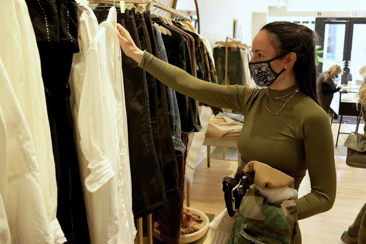 Jordan Green, of Westport, whose mother operated Wish List, looks over the merchendise at Unsubscribed on Saturday, April 3, 2021, in Westport, Conn.