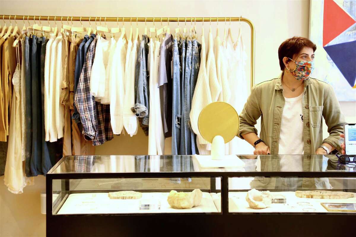 Lauren Schwartz, manager of Unsubscribed, welcomes customers on Saturday, April 3, 2021, in Westport, Conn.