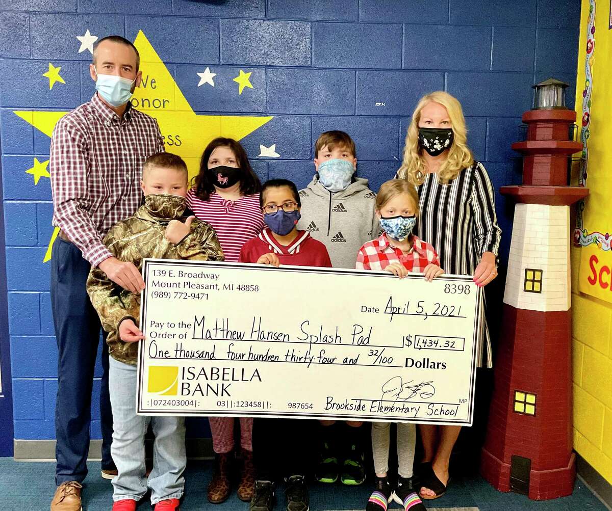 On Monday, Brookside Elementary students presented a check for over $1,400 to Jon Cole, chairperson of the Hemlock Park Improvement Project. The funds were raised through a month-long coin drive and will go toward the Matthew Hansen Memorial Splash Pad. (Courtesy photo)