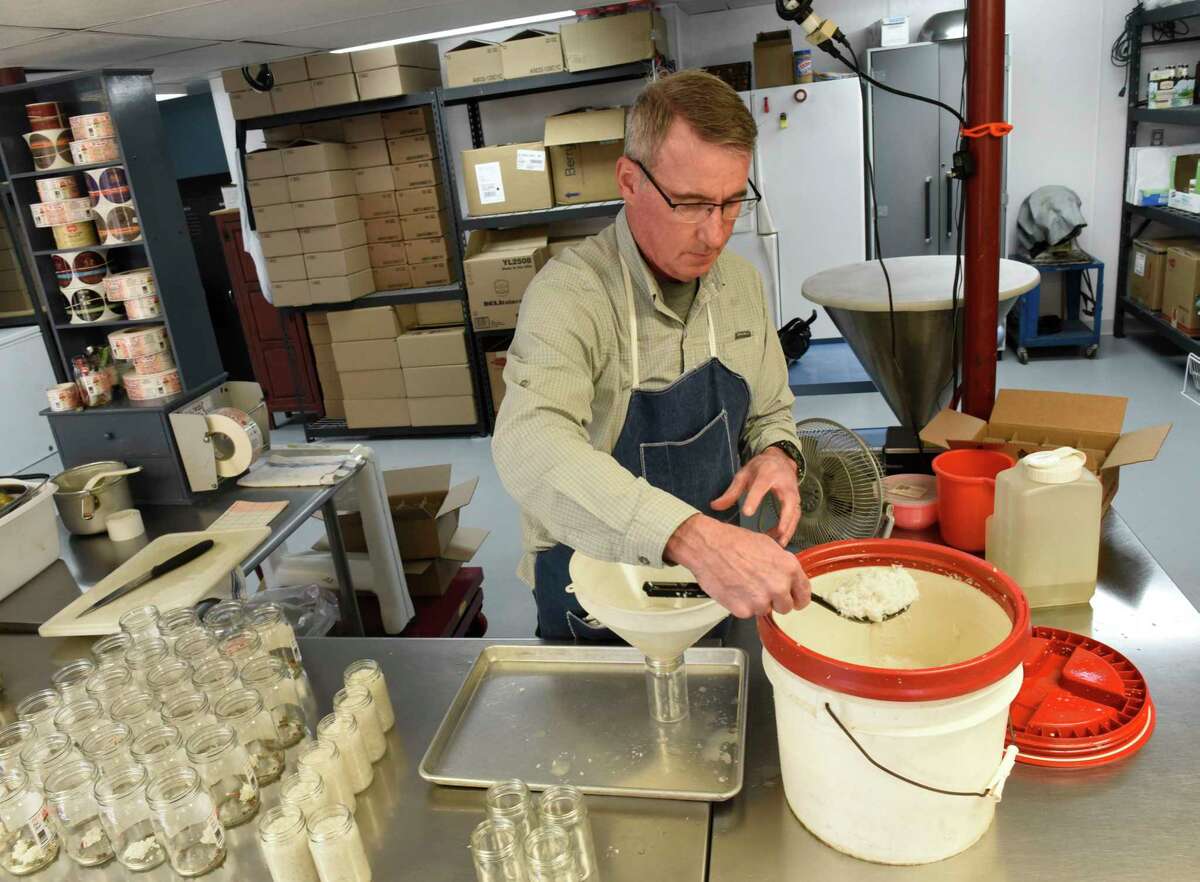 Owner Tim Bibens bottles up fresh horseradish in the production area of Whalen's Horseradish Products on Tuesday, March 30, 2021 in Galway, N.Y. (Lori Van Buren/Times Union)