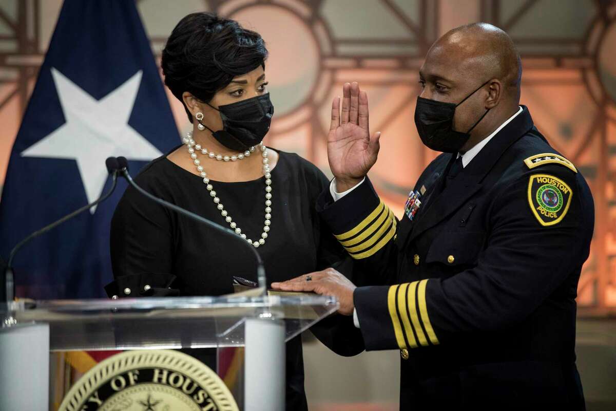 New Houston Police Chief Troy Finner, right, stands with his wife, Sherrian, as he is sworn in as the department's newest chief during a ceremony at City Hall Monday, April 5, 2021 in Houston. Finner is a 54-year-old veteran who hails from Fifth Ward and attended Madison High School in Houston. He formally takes the reins of the police department the same day that outgoing Chief Art Acevedo is sworn in as chief in Miami.