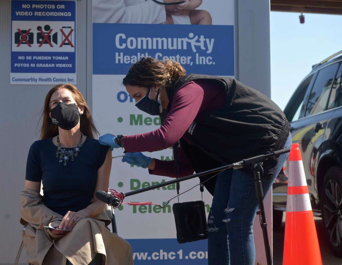 Lt. Governor Susan Bysiewicz receives her second dose of COVID_19 vaccine from Leonela Espinal RN before at the Community Health Center's mass vaccination clinic at the Danbury Fair mall. Monday, April 5, 2021, in Danbury, Conn.