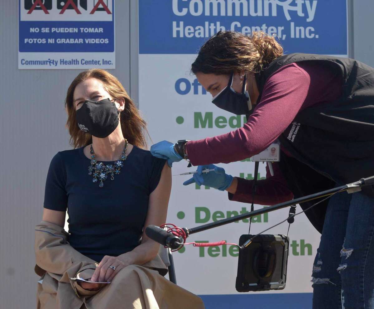 Lt. Governor Susan Bysiewicz receives her second dose of COVID_19 vaccine from Leonela Espinal RN before at the Community Health Center's mass vaccination clinic at the Danbury Fair mall. Monday, April 5, 2021, in Danbury, Conn.