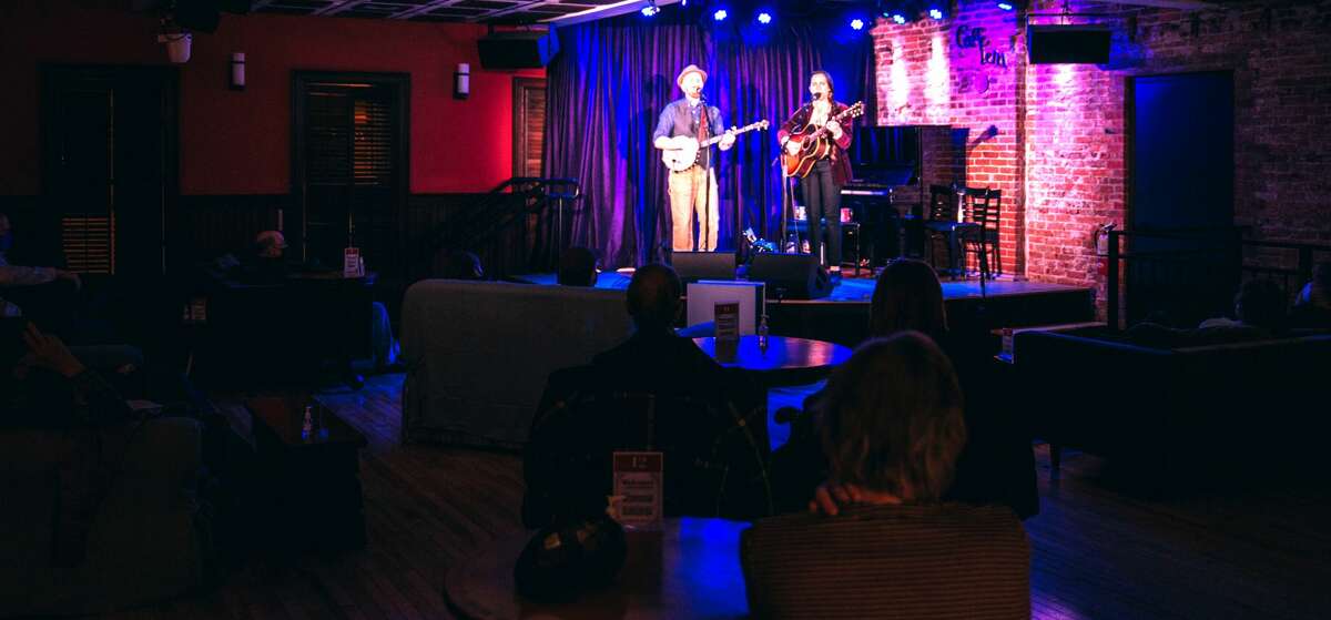 Robinson & Rohe perform on reopening night — April 2, 2021 — at Caffe Lena in Saratoga Springs. For the foreseeable future at the venerable coffeehouse, audiences will be limited to 34 or less for concerts, which will last about 75 minutes, no intermission. No food or drink is available, allowing all patrons to stay masked throughout. (Katie Dobies Photography.)
