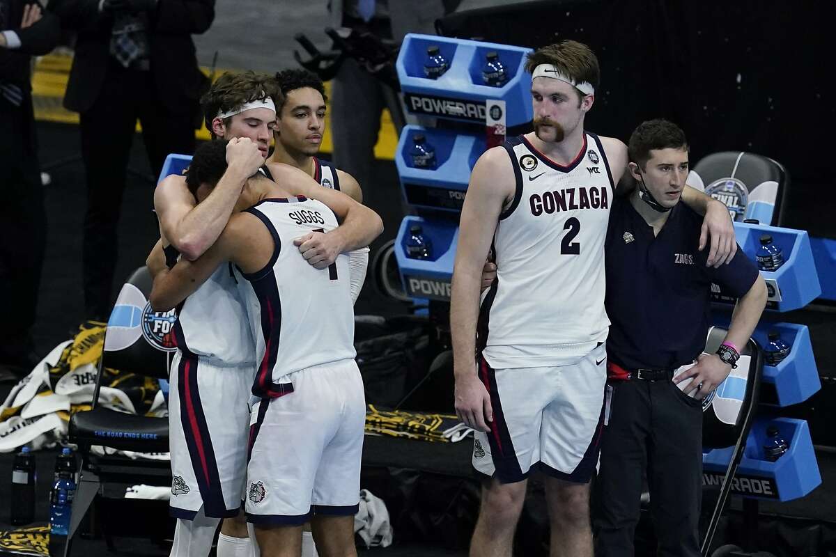 Gonzaga forward Corey Kispert (24) hugs Jalen Suggs (1) as Gonzaga forward Drew Timme (2) looks on at the end of the championship game against Baylor in the men's Final Four NCAA college basketball tournament, Monday, April 5, 2021, at Lucas Oil Stadium in Indianapolis. Baylor won 86-70.