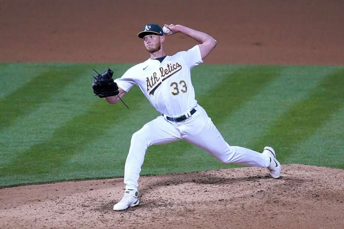 Oakland Athletics' A.J. Puk throws against the Los Angeles Dodgers during a baseball game in Oakland, Calif., Monday, April 5, 2021. (AP Photo/Jeff Chiu)