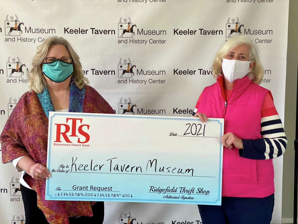 Keeler Tavern Museum & History Center Board President Rhonda Hill, left, recently accepted a grant from Ridgefield Thrift Shop volunteer Christine Nolan, right.