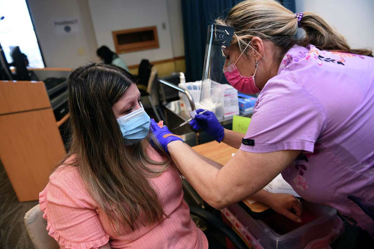 Teresa Goncalves (left) receives a Pfizer COVID-19 vaccination from LPN Nicola Frizell at the West Haven VA Medical Center on April 6, 2021. Goncalves is the wife of a veteran and is the beneficiary of the SAVE LIVES Act, Strengthening and Amplifying Vaccination Efforts to Locally Immunize all Veterans and Every Spouse which provides COVID-19 vaccinations for veterans along with their spouses and caregivers.