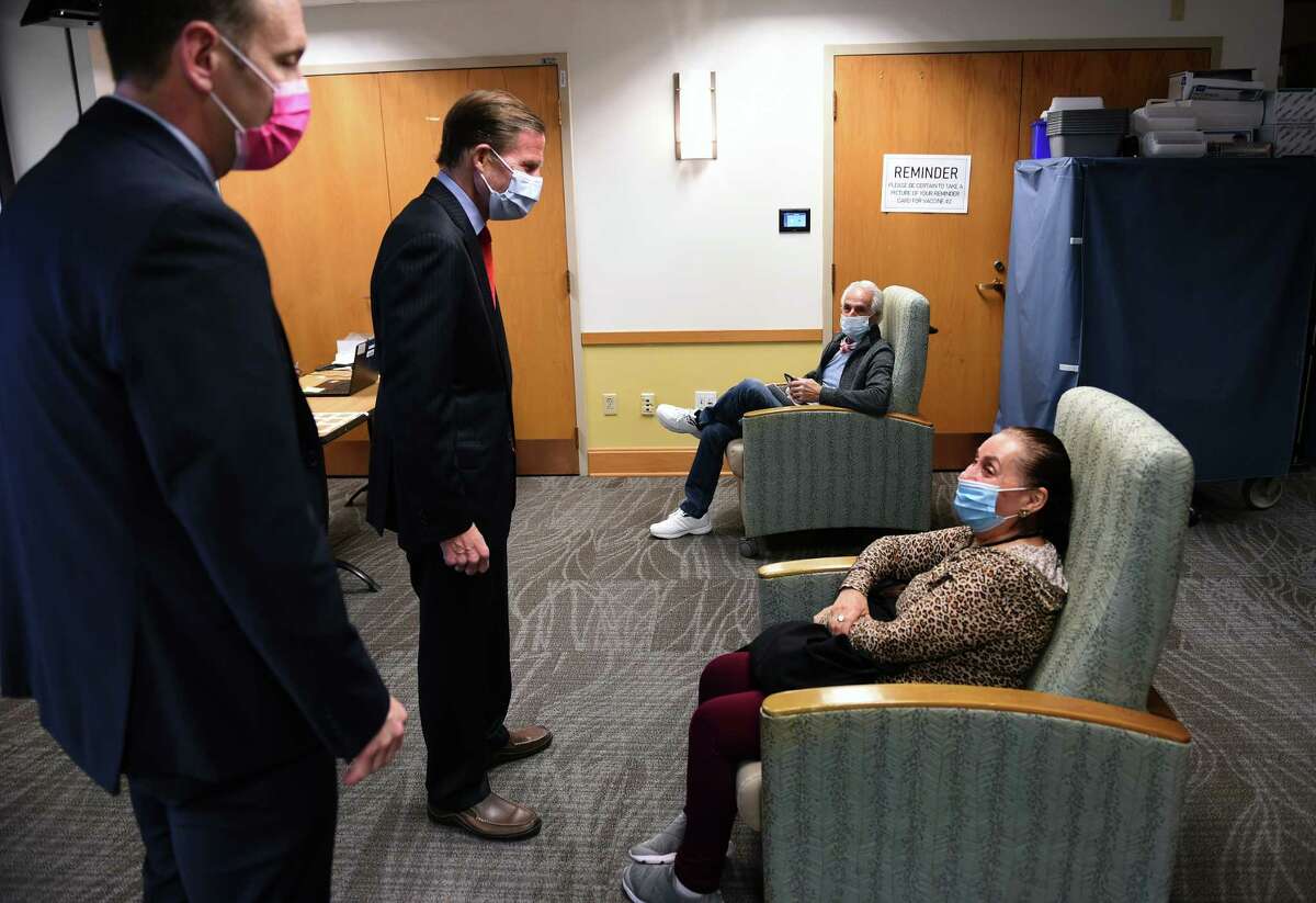 From left, Alfred Montoya, Jr., director of the VA Connecticut Healthcare System, and U.S. Senator Richard Blumenthal speak with Tony Fiorenzi and his wife, Sophia, of Waterbury after they received Pfizer COVID-19 vaccinations at the West Haven VA Medical Center on April 6, 2021. Blumenthal and Montoya spoke at a press conference about the SAVE LIVES Act, Strengthening and Amplifying Vaccination Efforts to Locally Immunize all Veterans and Every Spouse which provides COVID-19 vaccinations for veterans along with their spouses and caregivers.