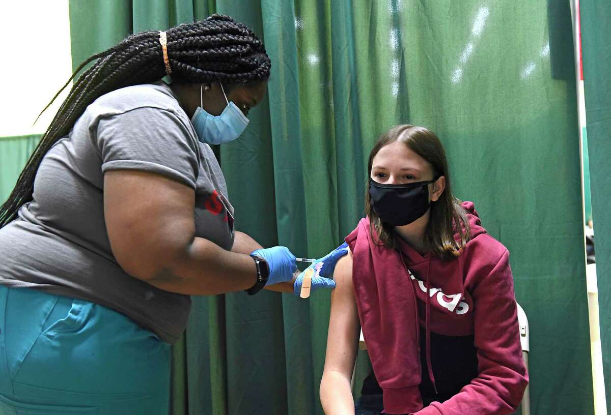 Davaisha Springsteen, LPN administers sophomore Morgan Tambolleo’s first Pfizer COVID-19 vaccine at Siena College on Tuesday, April 6, 2021 in Loudonville, N.Y. 500 Siena students pre-registered for the clinic. (Lori Van Buren/Times Union)