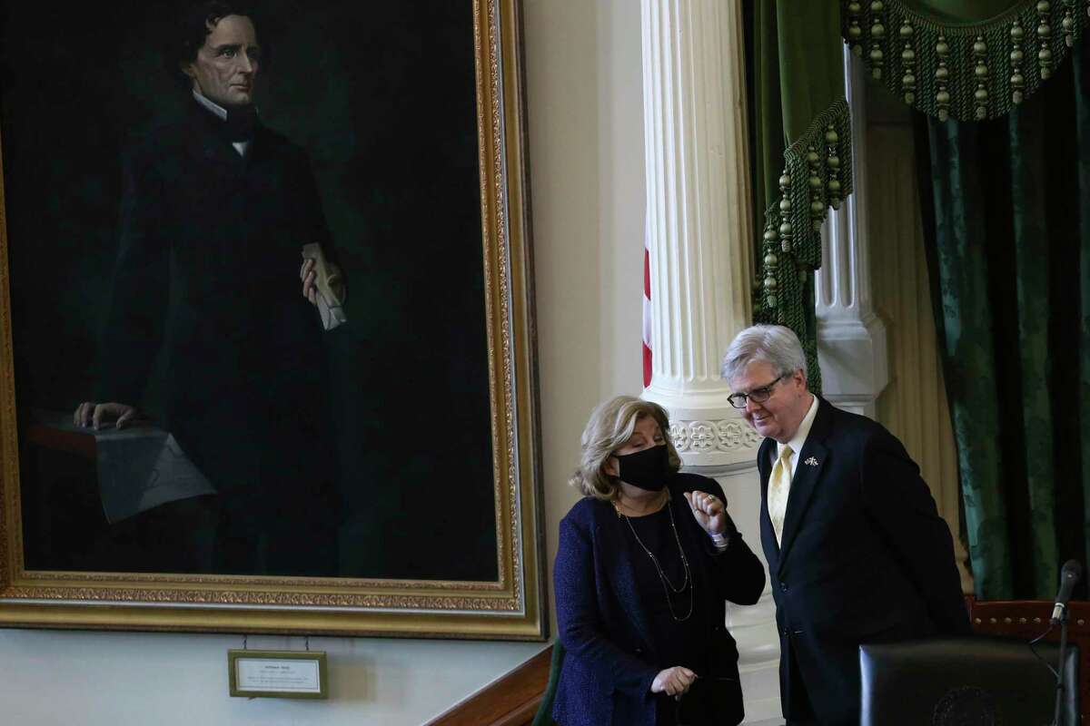 Texas State Sen. Jane Nelson, R-Flower Mount, talks with Lt. Gov. Dan Patrick as the 87th legislature reconvenes, Tuesday, Feb. 9, 2021. On their left is a portrait of Confederate President Jefferson Davis.
