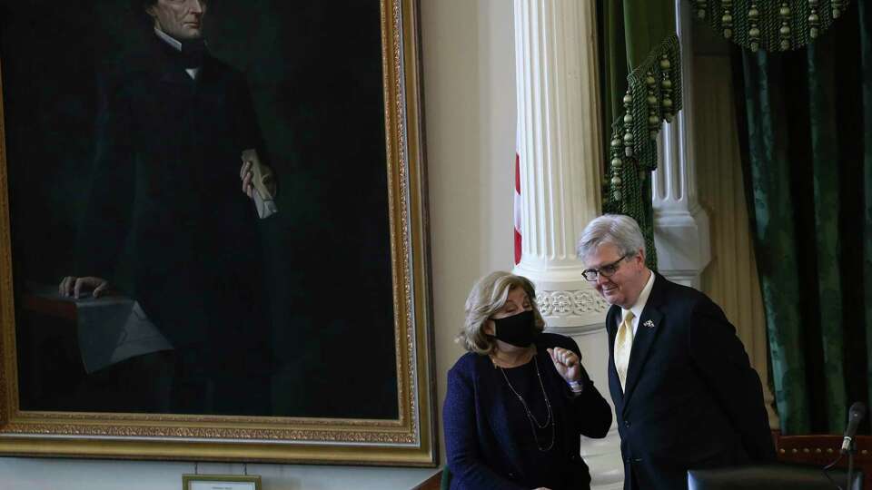 Texas State Sen. Jane Nelson, R-Flower Mount, talks with Lt. Gov. Dan Patrick as the 87th legislature reconvenes, Tuesday, Feb. 9, 2021. On their left is a portrait of Confederate President Jefferson Davis.