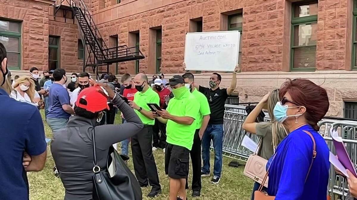 More than 200 people assembled on the grounds of the Bexar County Courthouse Tuesday for mortgage and tax foreclosure sales.