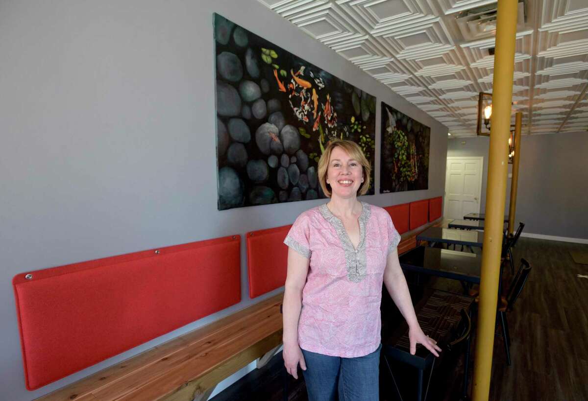 Anna Llamos owner of ItadakiMÀS Restaurant at 317 Main Street, in Danbury, Conn, April 2, 2021. The art work on the wall behind he was painted by her daughter Abigail Llanos.