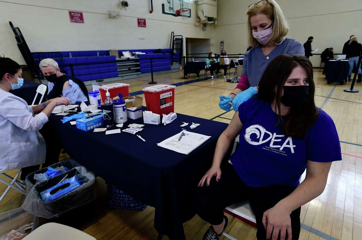 Darien Superintendent of Schools Alan Addley and Darien teachers' union president, Joslyn Delancey, get vaccinated against the coronavirus March 6, at Town Hall in Darien.
