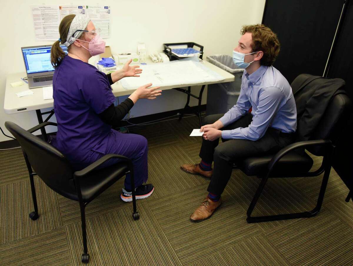 State Sen. Will Haskell, D-New Canaan, speaks with Carly Plymel, RN, before receiving his first dose of the COVID-19 vaccine at the Stamford Health Vaccination Super Site in Stamford, Conn. Tuesday, April 6, 2021. Beginning April 1st , all individuals 16 and older who live, work, or attend school in Connecticut became eligible to receive the COVID-19 vaccine.