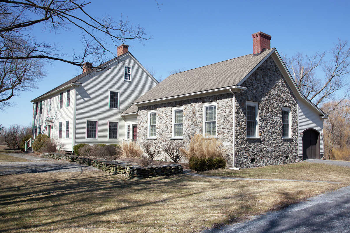 3307 County Route 21, Kinderhook. This week’s house is a classic wood clapboard Colonial with a field stone addition. It was built in 1995 on 56 acres. The lot also has on it a barn, a 3-bay carriage house and a cottage. The house has 5,216 square feet of living space. It has four bedrooms and four bathrooms, plus an additional bedroom and bathroom in the guest house. There are six wood-burning fireplaces, a screened porch, a bar in the walk-out basement and a pond lined with willows. Private well and septic, oil heat. Ichabod Crane schools. Taxes: $35,000. List price: $1,995,000. Contact listing agent Mary Stapleton with Berkshire Hathaway HomeServices Blake, Realtors at 518-929-7783.