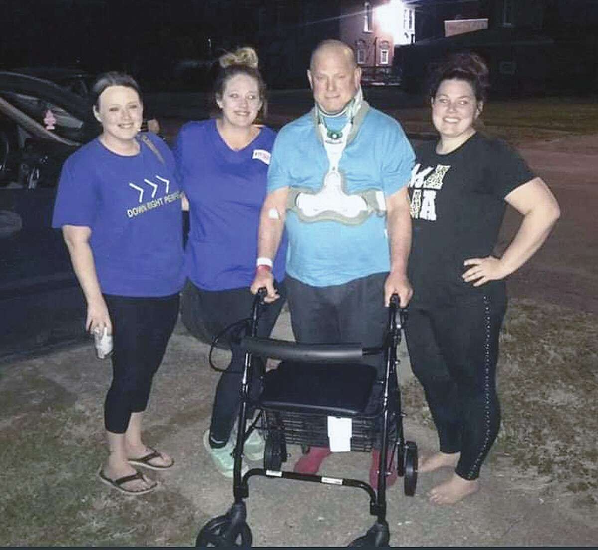 Mike Graham arrives home from the hospital with family members Kayla Bollinger (from left), Alexis Graham and Mikka Graham. Mike Graham was injured when he fell 15 feet off of a ladder.