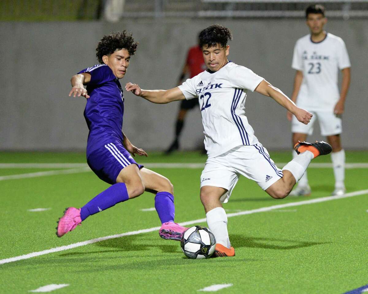 Michael Navarro (13) of Jersey Village challenges Elvin Turcios (22) of Elsik during the second half of a 6A-III regional semifinal soccer match between the Elsik Rams and the Jersey Village Falcons on Tuesday, April 6, 2021 at Legacy Stadium, Katy, TX.