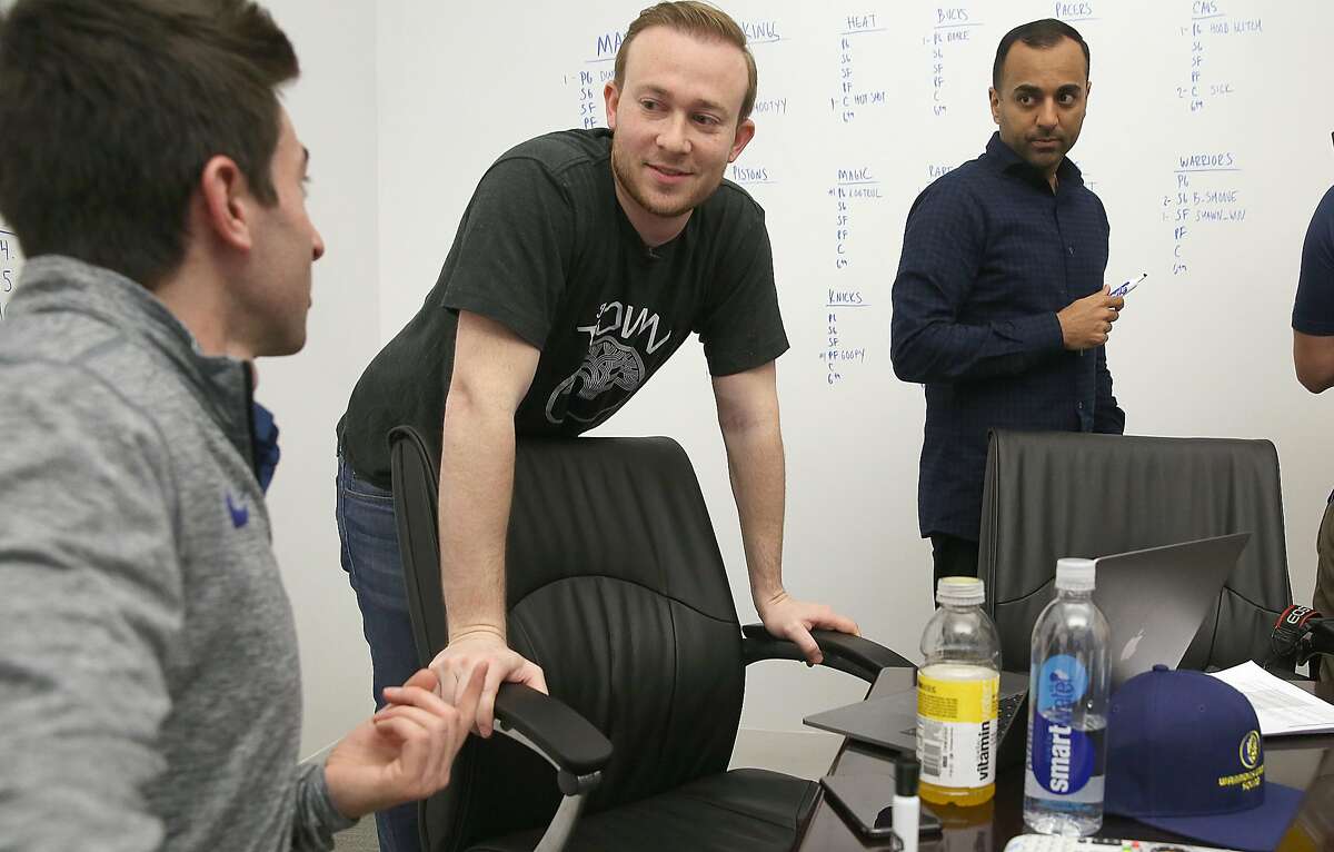 General manager for Santa Cruz Warriors Kent Lacob (left), VP of GSW sports ventures Kirk Lacob (middle) and director of basketball analytics Pabail Sidhu (right) from the Warriors' Gaming Squad gather at the Warriors offices in downtown Oakland to watch the proceedings on a screen and make decisions on top prospects on Wednesday, April 4, 2018, in Oakland, Calif.