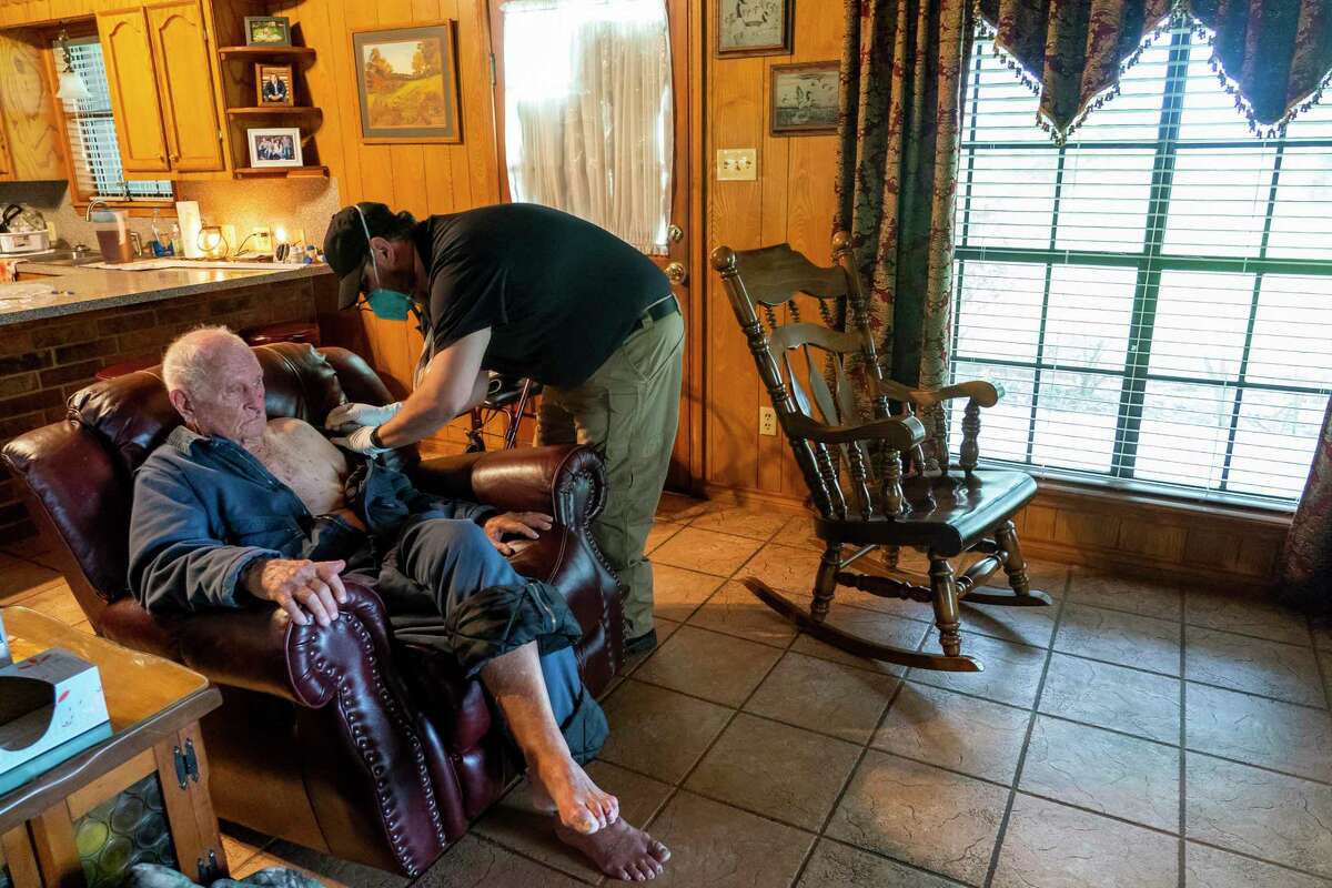 Chambers County paramedic Danny Burke administers a second dose of the Moderna COVID-19 vaccine to Guerry Hahn, 92, on Tuesday, April 6, 2021, in Anahuac, TX. Hahn was receiving the vaccine at the same time as his daughter, who is his caretaker, as part of the county's mobile vaccination program. Hahn got sick with Covid earlier in the pandemic, but weathered the virus without any serious complications.