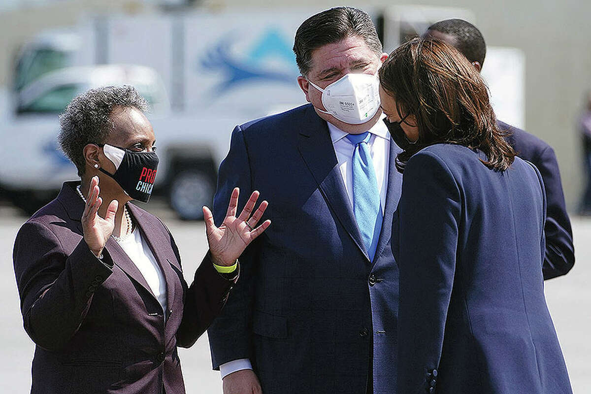 Vice President Kamala Harris greets Chicago Mayor Lori Lightfoot and Gov. J.B. Pritzker as she arrives in Chicago on Tuesday. Some lawmakers from both political parties are criticizing the state's handling of grants intended to help businesses during the pandemic.
