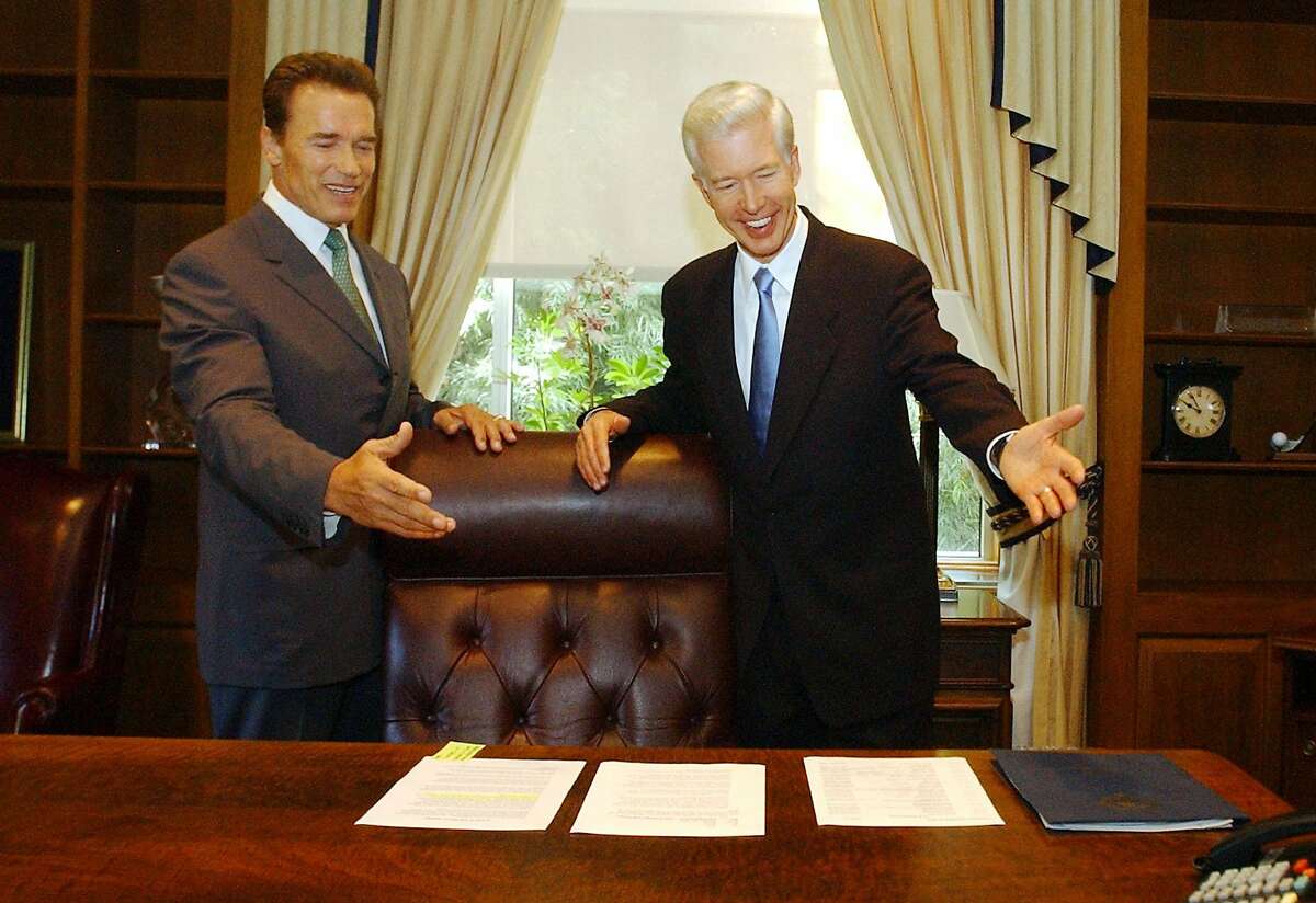 2003年10月，当选州长阿诺德·施瓦辛格(左)在选民罢免即将卸任的州长格雷·戴维斯后与他开玩笑。