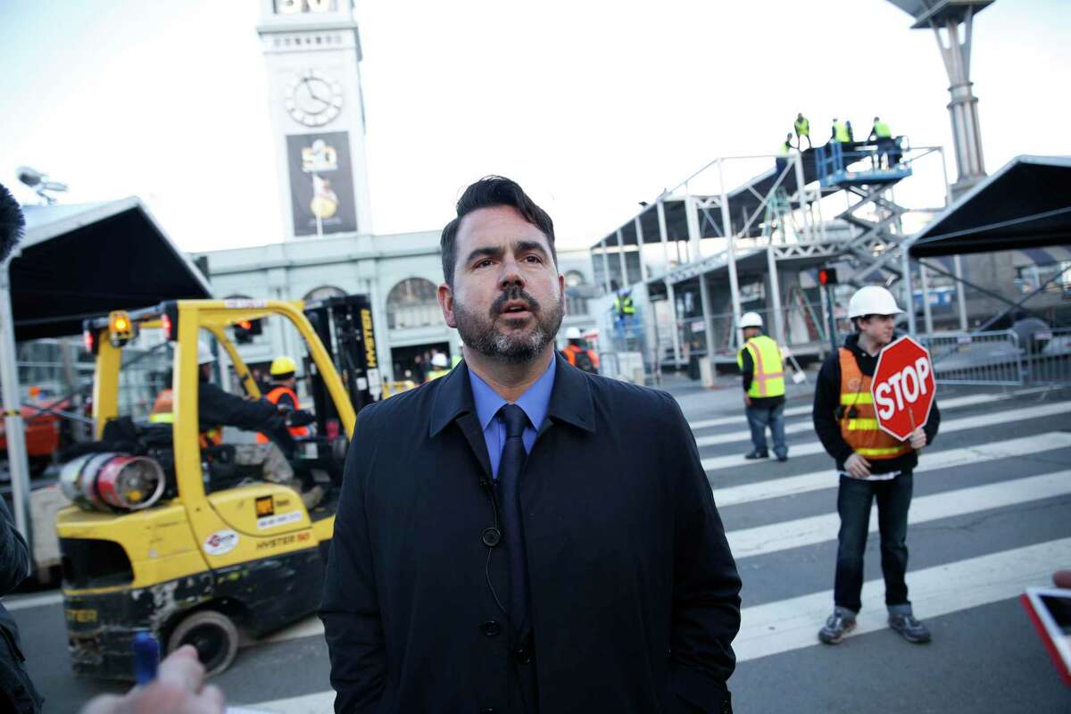 Nathan Ballard, then the spokesman for the Super Bowl 50 host committee, stands along San Francisco’s Embarcadero amid Super Bowl City construction in early 2016.