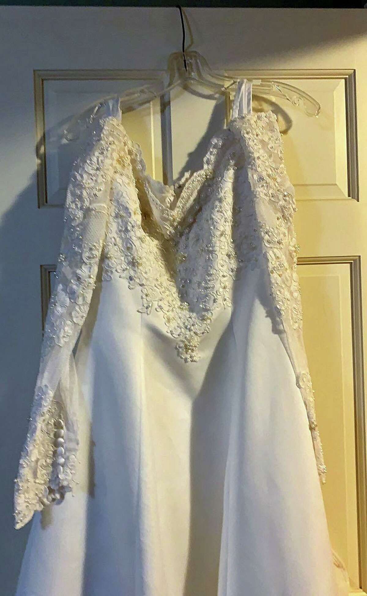Chris Clorite's wedding gown, returned after 24 years in storage at the General's Residence. Below,