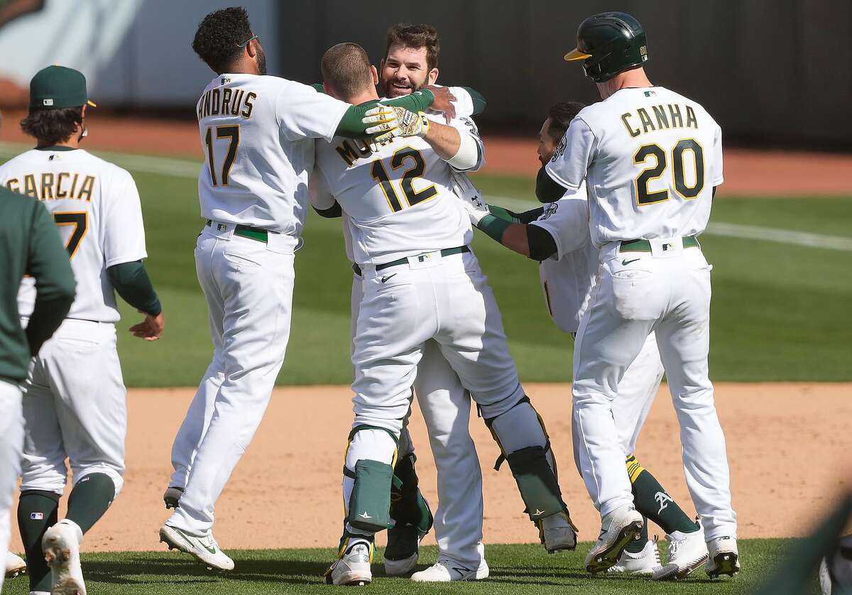 Mitch Moreland (12) celebrates good times Wednesday with his teammates after his game-winnng hit at the Coliseum.
