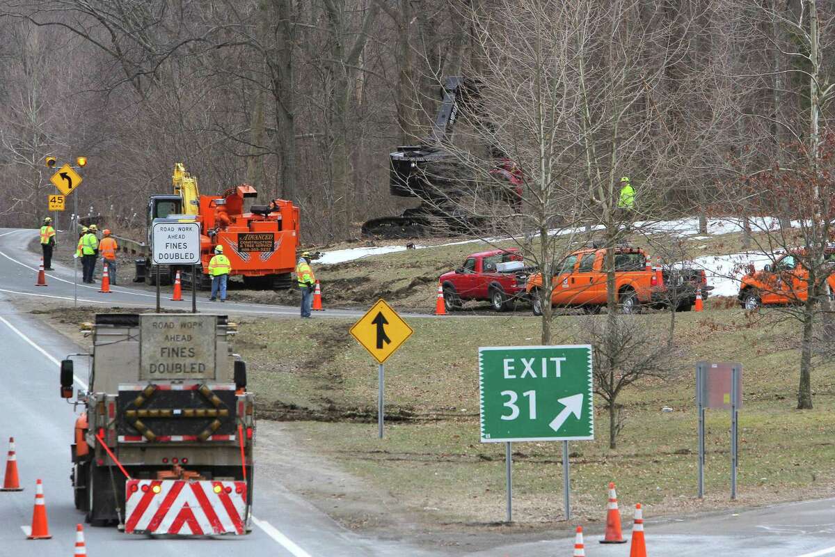 A crew from the Connecticut Department of Transportation clear trees along the Northbound Merritt Parkway at Exit 31 for North Street in Greenwich, Connecticut, in 2018.