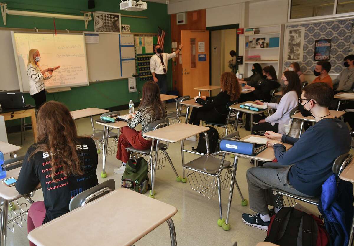 Teacher Katie Poole's calculus students enjoy a return to a full classroom for the first time in a year at Ludlowe High School in Fairfield, Conn. on Tuesday, March 9, 2021.