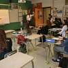 Teacher Katie Poole's calculus students enjoy a return to a full classroom for the first time in a year at Ludlowe High School in Fairfield, Conn. on Tuesday, March 9, 2021.