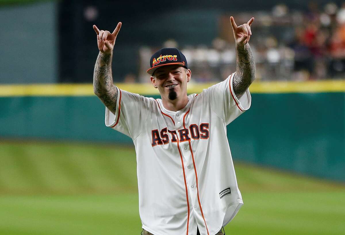 Rapper Paul Wall reacts after throwing out the first pitch before the start of an MLB game at Minute Maid Park,Tuesday, Aug. 16, 2016, in Houston. ( Karen Warren / Houston Chronicle )