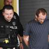 Daniel Shackleford is escorted to a police car from the Port Arthur Police Station. Photo taken on Thursday, 03/07/19. Ryan Welch/The Enterprise