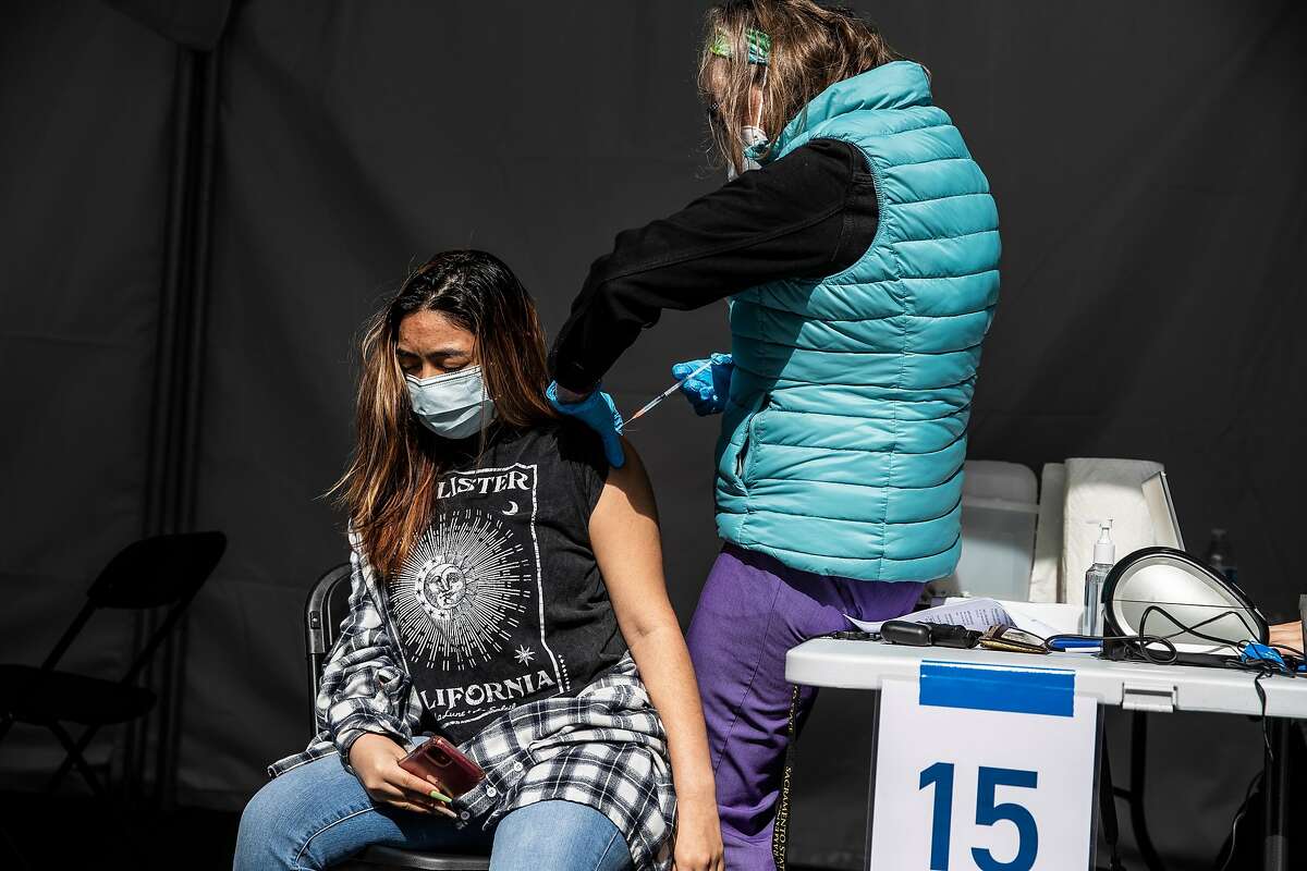 Nurse Taryn Huestis prepares to inoculate Samaya Pupiro at a neighborhood COVID-19 vaccination site in the Excelsior district of San Francisco, California Wednesday April 7, 2021.