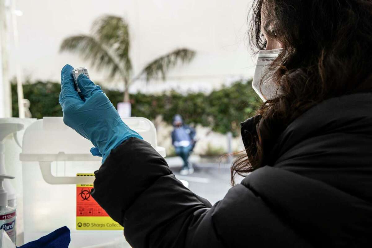 Nurse Joy Ceniza prepares a dosage of Moderna COVID-19 vaccine at a neighborhood vaccination site in the Excelsior district of San Francisco, California Wednesday April 7, 2021.