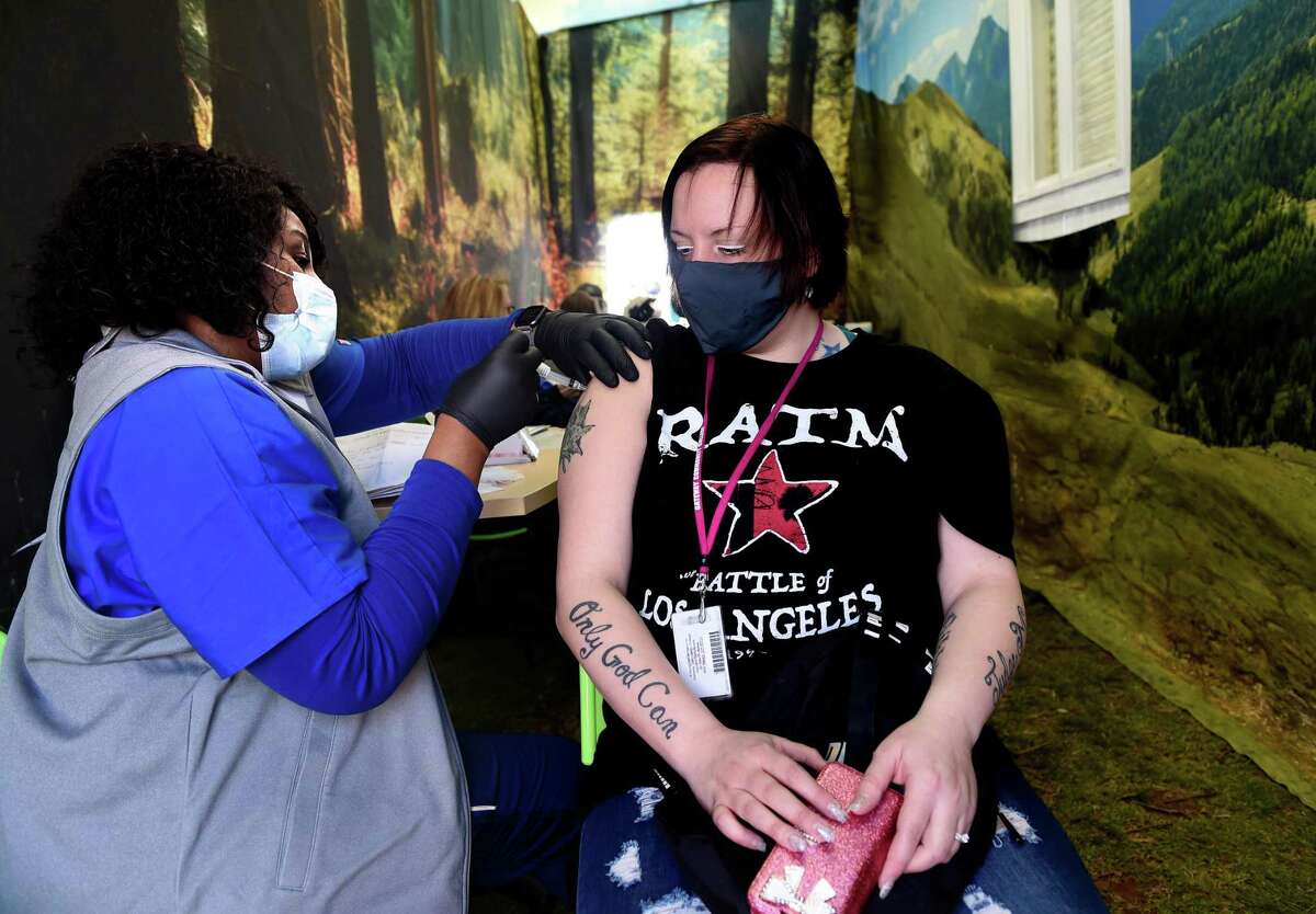 Griffin Hospital RN Cynthia Dore (left) gives Nikkita Hiraldo of New Haven Johnson & Johnson COVID-19 vaccination at a COVID-19 FEMA Mobile Vaccination Unit set up on the New Haven Green on April 8, 2021.