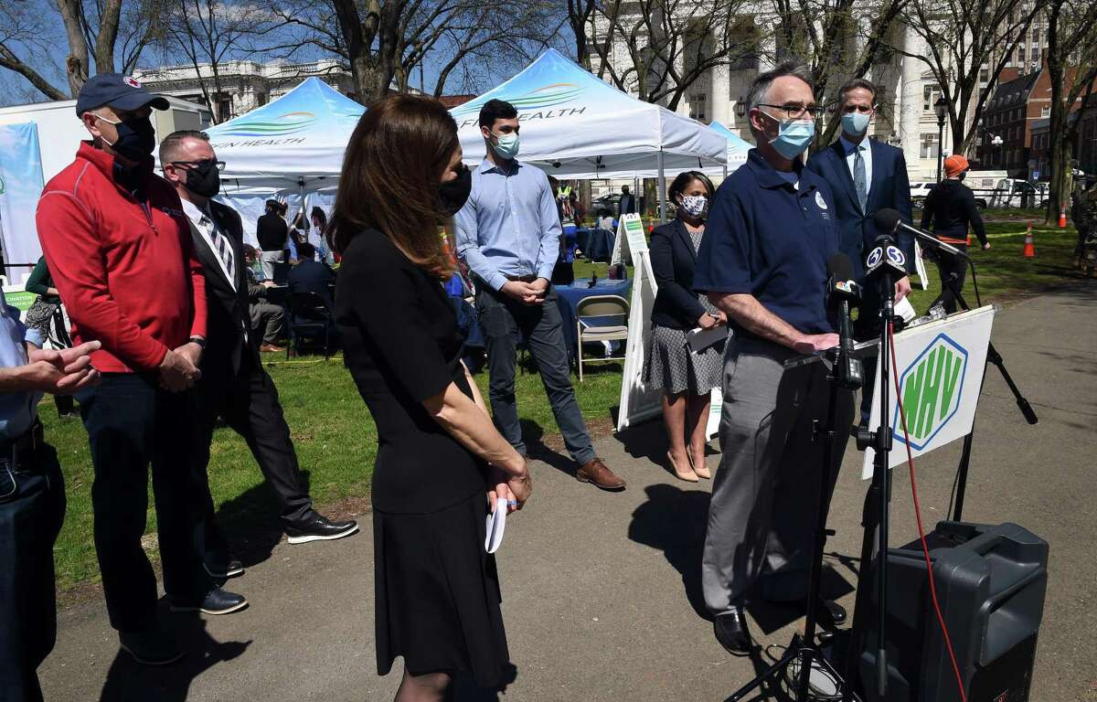 Dan McElhinney (right), acting deputy regional administrator for the Federal Emergency Management Agency, speaks at a press conference at the site of a COVID-19 FEMA Mobile Vaccination Unit on the New Haven Green on April 8, 2021.
