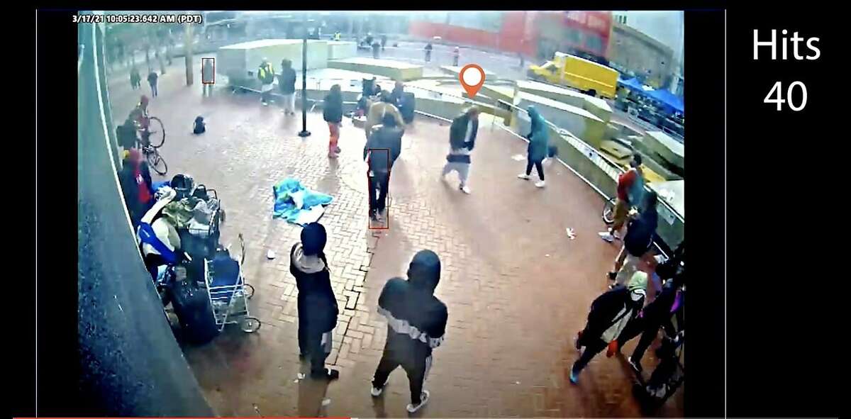 Screen captures of surveillance camera footage purporting to show Steven Jenkins being surrounded and hit by several individuals shortly before Jenkins attacked two older Asian adults on Market Street in San Francisco.
