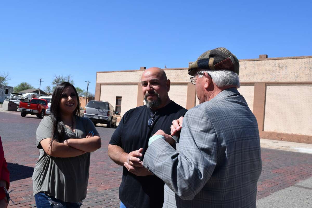 Mayor Charles Starnes talks with artist Alfonso Garcia about his artwork in downtown Plainview.