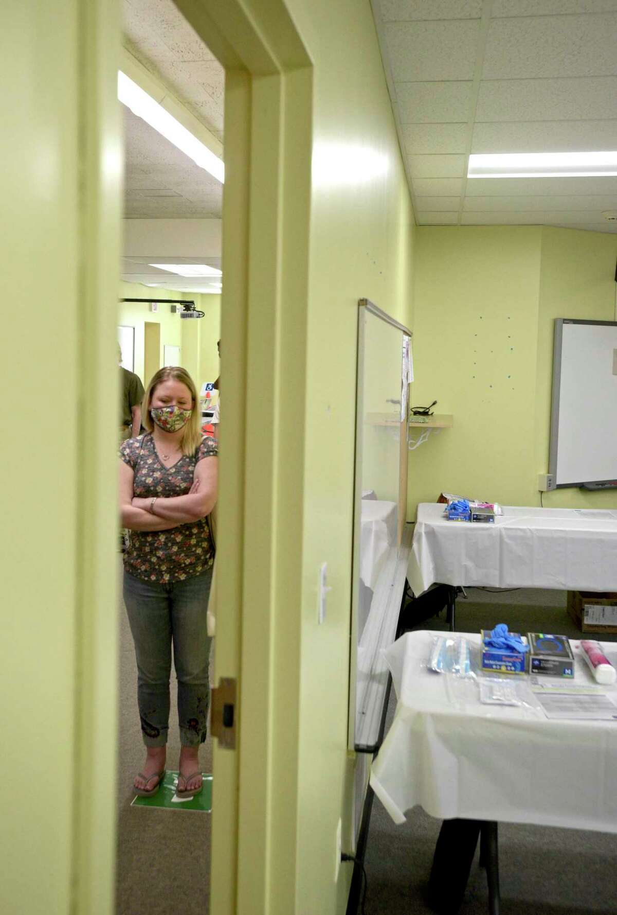 Jennifer Barabas, of Brookfield, waits to received her first dose of COVID-19 vaccine at the new location of the Brookfield clinic, set up at the old St Joseph Catholic Academy. Wednesday, April 8, 2021, in Brookfield, Conn.