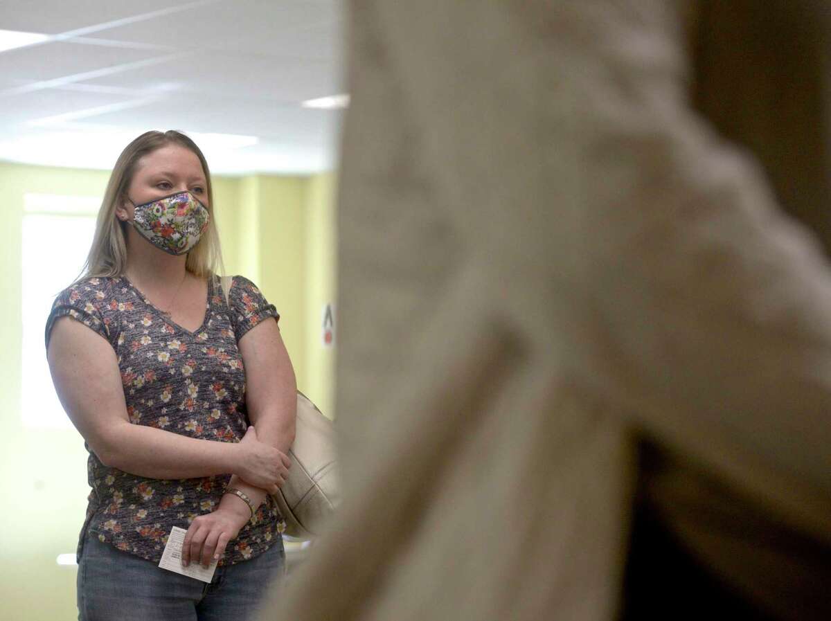 Jennifer Barabas, of Brookfield, waits to received her first dose of COVID-19 vaccine at the new location of the Brookfield clinic, set up at the old St Joseph Catholic Academy. Wednesday, April 8, 2021, in Brookfield, Conn.