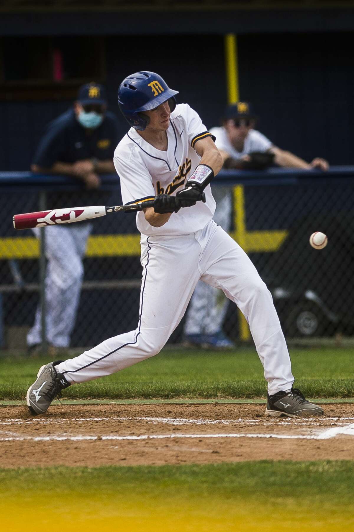 Midland's Joshua Doyle swings on a pitch during the Chemics' game against Traverse City West Thursday, April 8, 2021 at Midland High School. (Katy Kildee/kkildee@mdn.net)