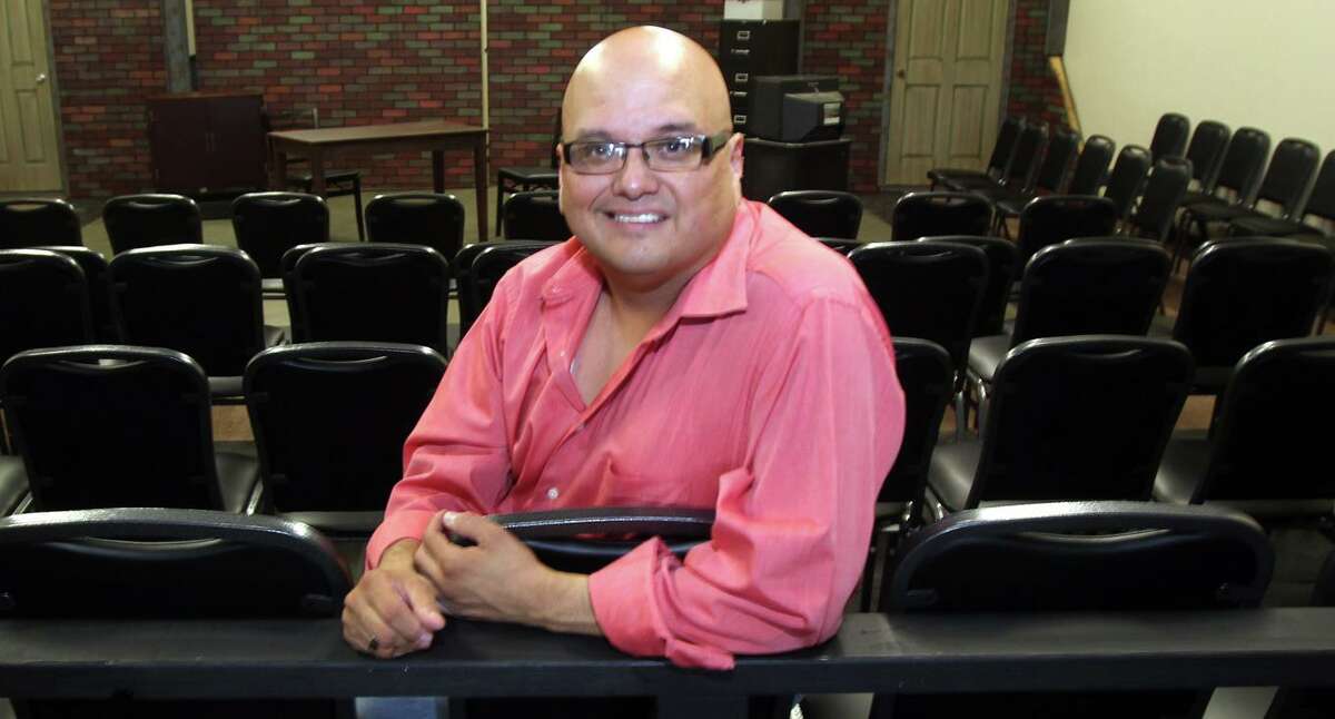 Actor and director Greg Hinojosa sits in the black box theater at the Woodlawn Theater, which he ran for a couple of years. Hinojosa died on Thursday.