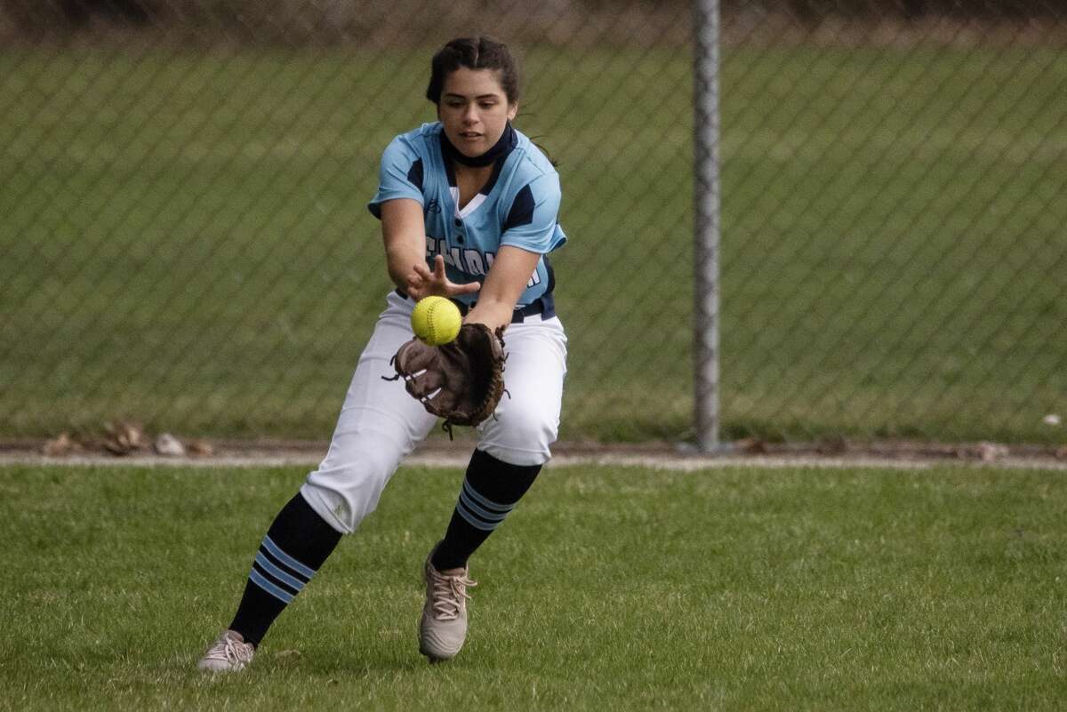 Meridian's Jenna Holzinger fields a ball during a game against Dow Thursday, April 8, 2021 at Merdian Early College High School. (Isaac Ritchey/for the Daily News)