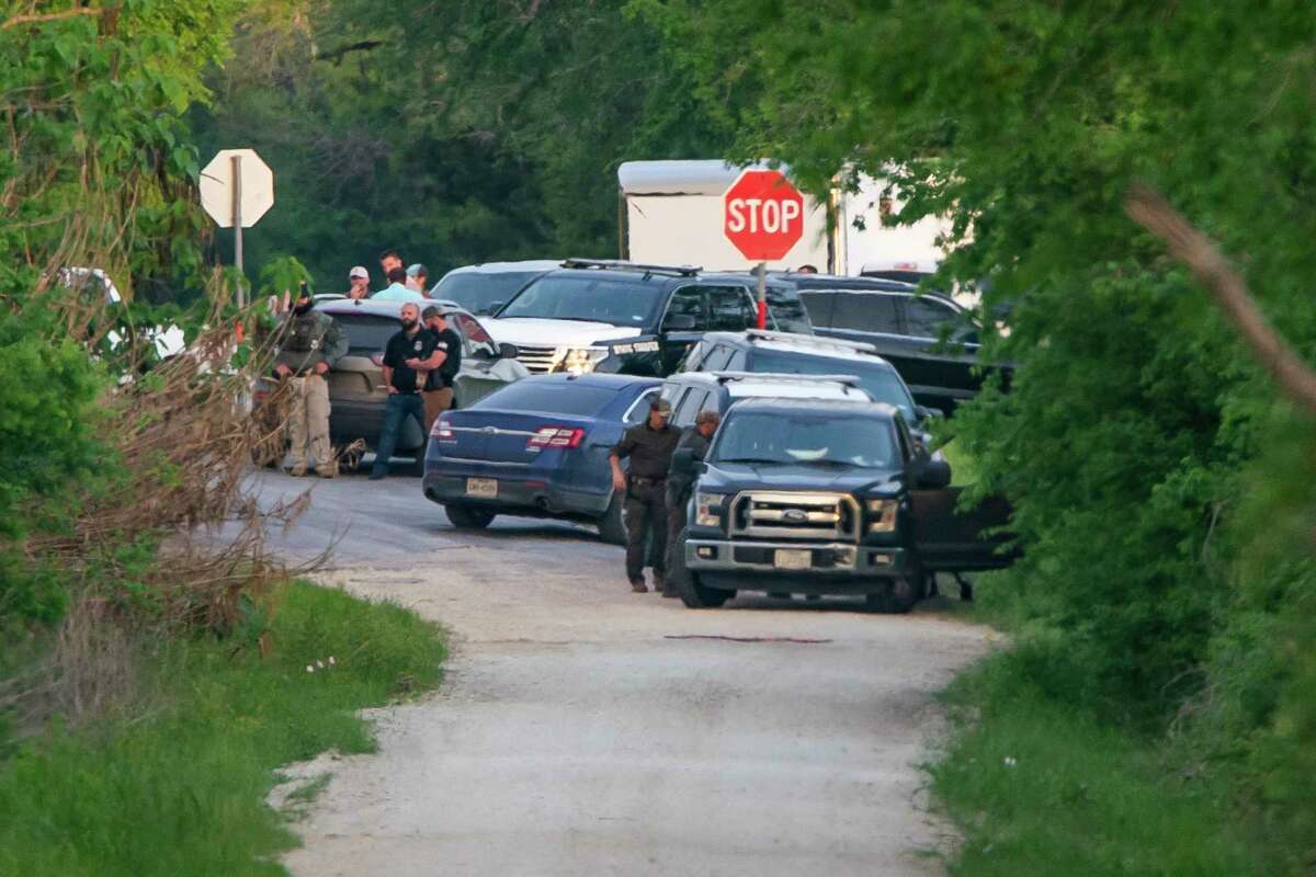 State and local police use use a speaker to talk to the possible occupants of a house near Iola near where a State Trooper was shot earlier in the day after an earlier shooting at Kent Moore Cabinets in Bryan on Thursday, April 8, 2021. At least one person is reported dead, and six people were hospitalized.
