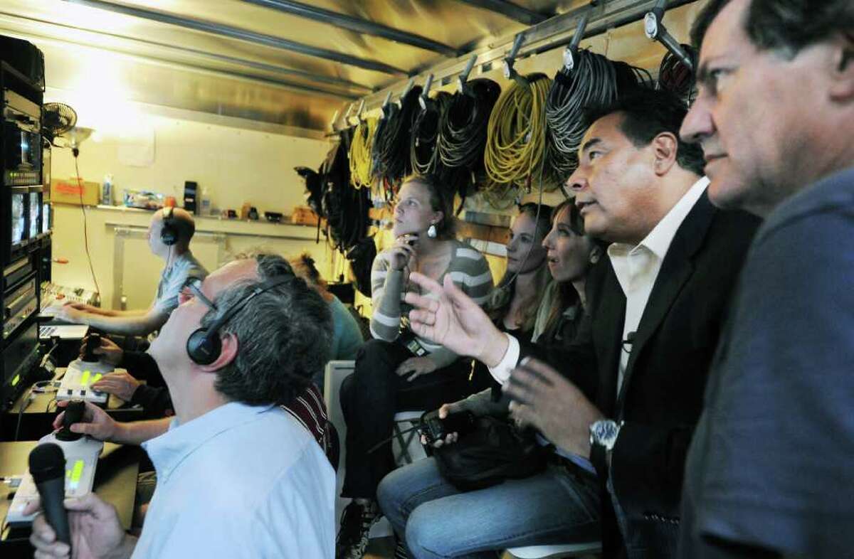 FILE — John Quinones, anchor of "What Would You Do?", discusses a scene in the production trailer with (far right) executive producer Chris Whipple, originally from Old Greenwich, on Forrest St. in Stamford, Conn. on Friday September 10, 2010